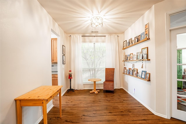 sitting room with dark hardwood / wood-style floors