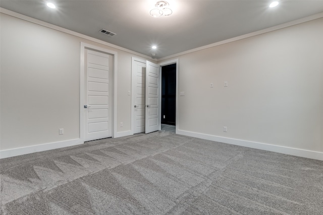 unfurnished bedroom with crown molding and light carpet