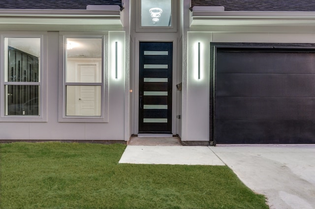 entrance to property with a yard and a garage