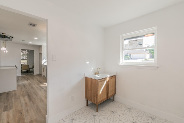 hall featuring light hardwood / wood-style flooring and sink