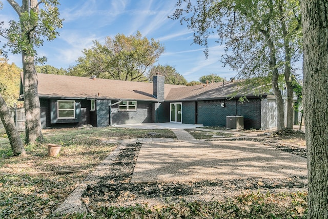 rear view of property with a patio and cooling unit