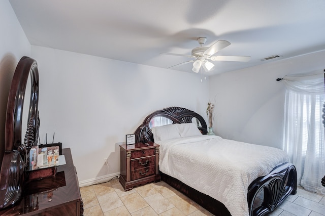 tiled bedroom with ceiling fan