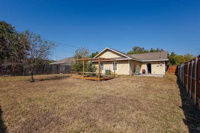 rear view of property featuring a patio area and a lawn