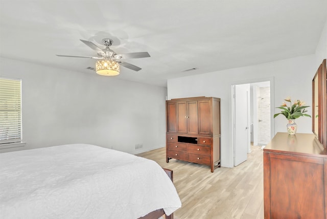 bedroom featuring ensuite bathroom, light hardwood / wood-style floors, and ceiling fan