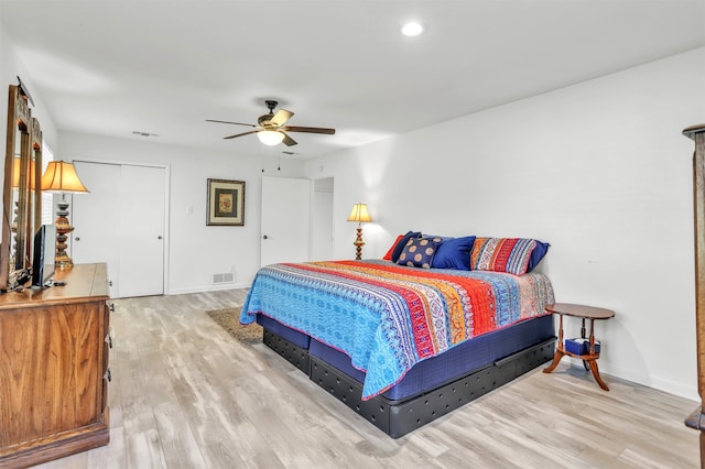 bedroom featuring hardwood / wood-style floors, a closet, and ceiling fan