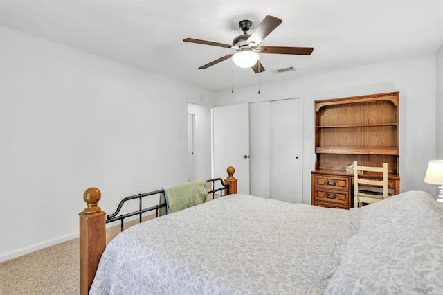 carpeted bedroom with a closet and ceiling fan