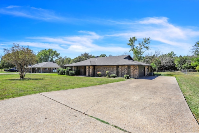 single story home featuring a front yard and a garage