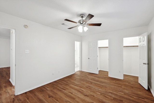 unfurnished bedroom featuring dark hardwood / wood-style floors and ceiling fan