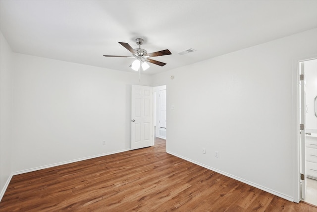 spare room with ceiling fan and hardwood / wood-style flooring