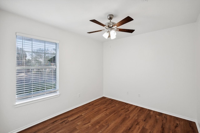 spare room featuring ceiling fan and dark hardwood / wood-style flooring