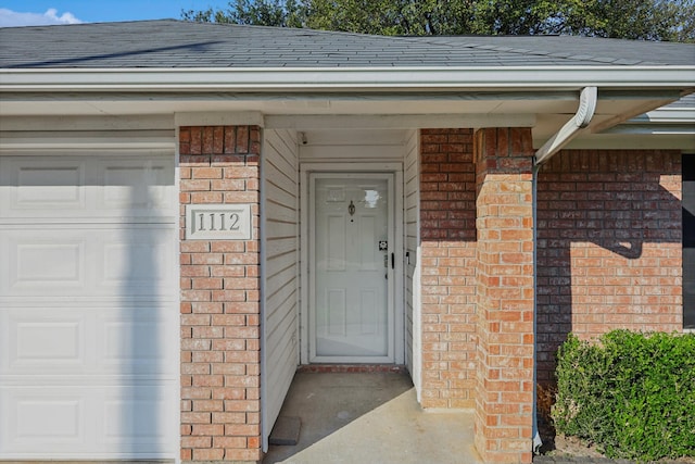 view of exterior entry featuring a garage