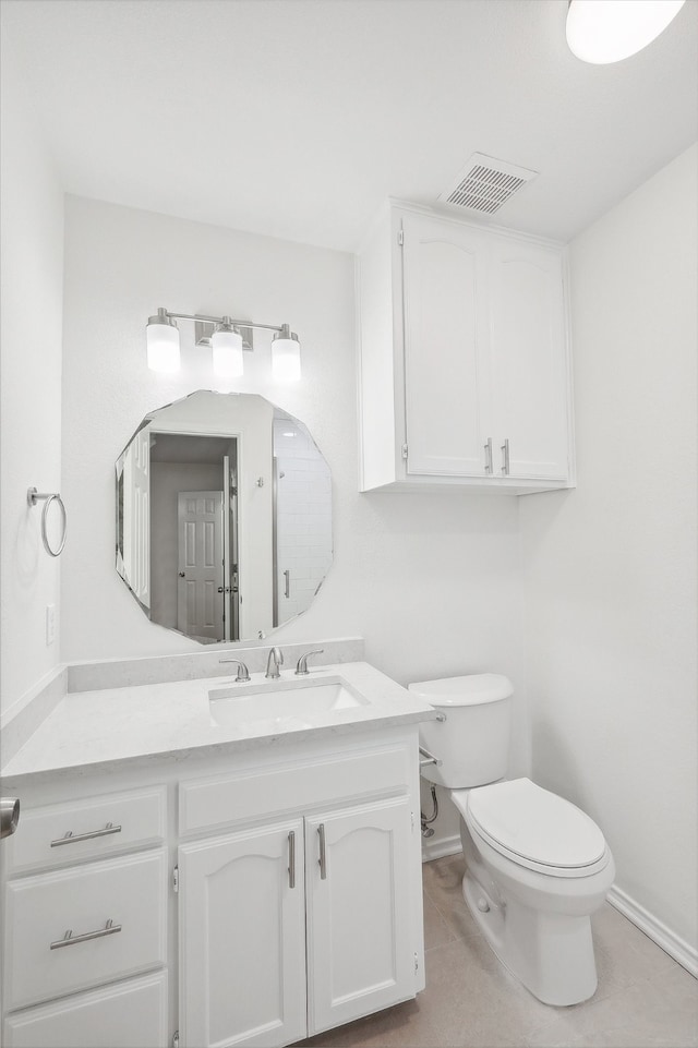 bathroom with vanity, toilet, and tile patterned flooring