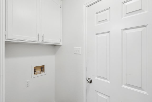 clothes washing area with hookup for a washing machine and cabinets