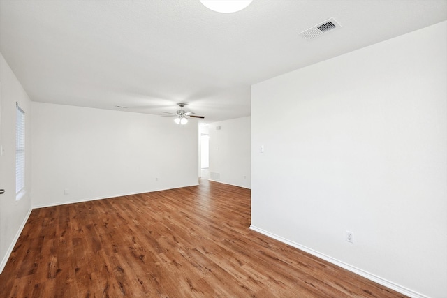 spare room with ceiling fan and wood-type flooring