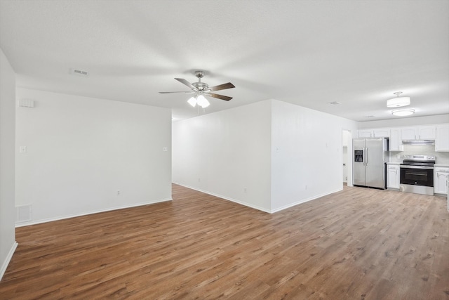 unfurnished living room featuring light hardwood / wood-style flooring and ceiling fan