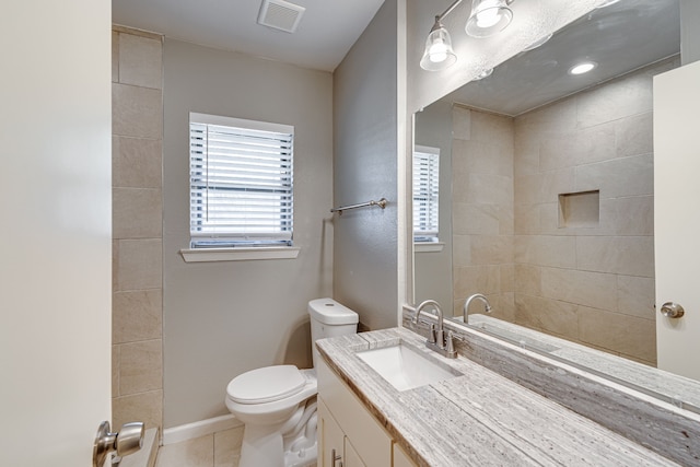 bathroom featuring toilet, vanity, and tile patterned flooring