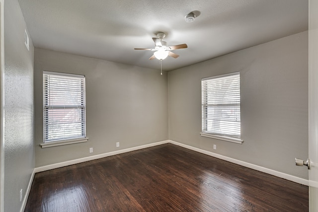 spare room featuring ceiling fan and dark hardwood / wood-style flooring