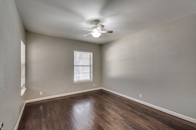 unfurnished room with dark hardwood / wood-style floors, a textured ceiling, and ceiling fan