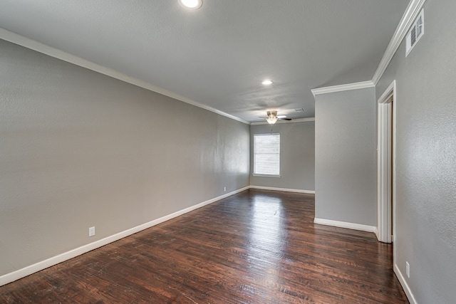 empty room featuring crown molding, dark wood-type flooring, and ceiling fan