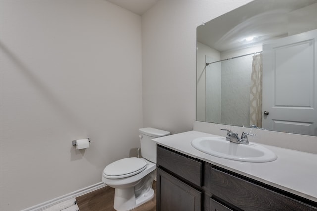 bathroom with vanity, a shower with curtain, toilet, and hardwood / wood-style flooring