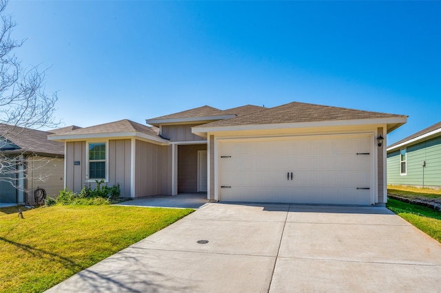 ranch-style house featuring a garage and a front lawn