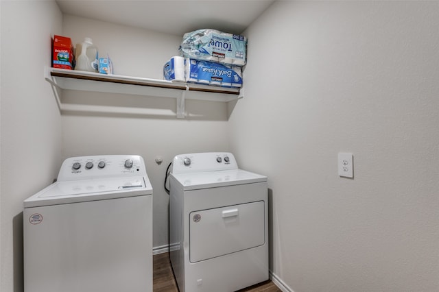 clothes washing area with dark hardwood / wood-style floors and washing machine and clothes dryer