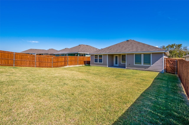 rear view of property with a lawn