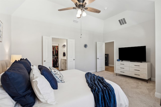 carpeted bedroom featuring lofted ceiling, ensuite bathroom, and ceiling fan