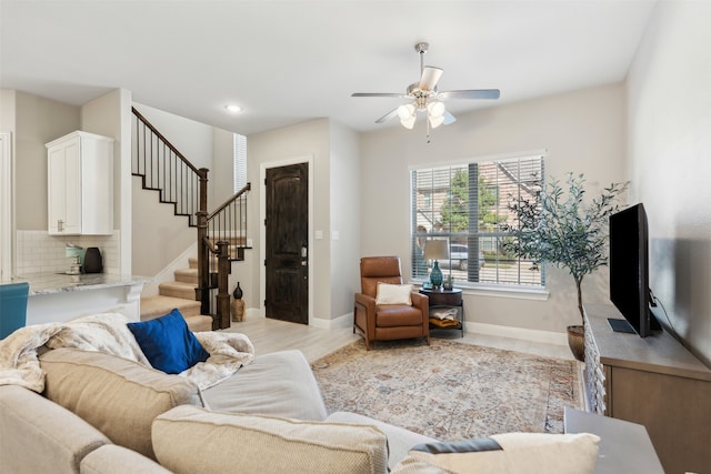 living room with light hardwood / wood-style floors and ceiling fan