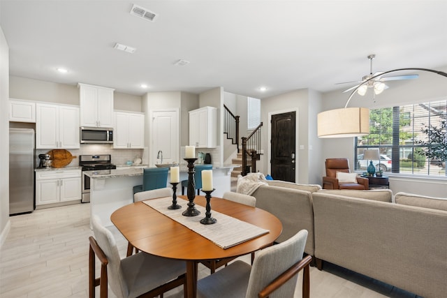 dining room with light hardwood / wood-style floors and ceiling fan