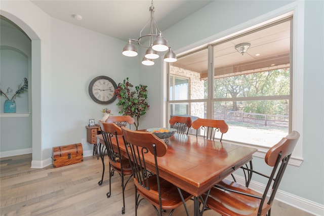 dining space featuring a chandelier and light hardwood / wood-style flooring