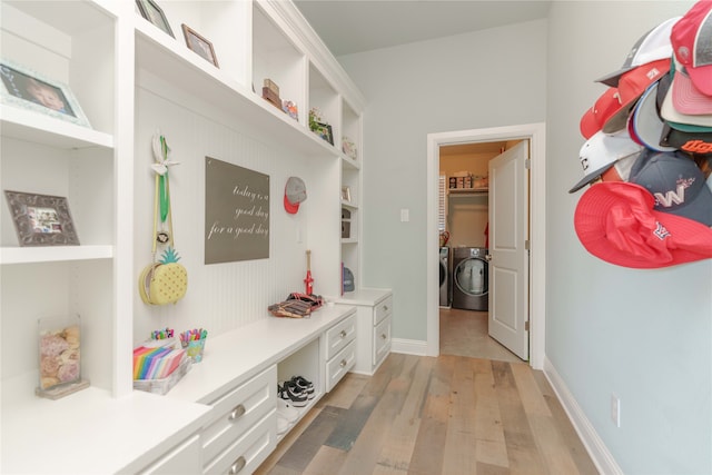 mudroom featuring light hardwood / wood-style floors and separate washer and dryer