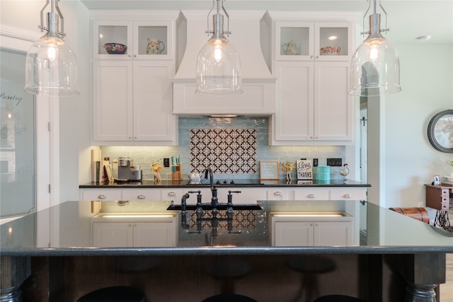 kitchen with a large island, decorative backsplash, and decorative light fixtures