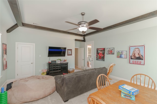 carpeted living room with beamed ceiling and ceiling fan