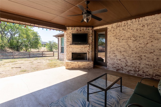 view of patio with an outdoor brick fireplace and ceiling fan