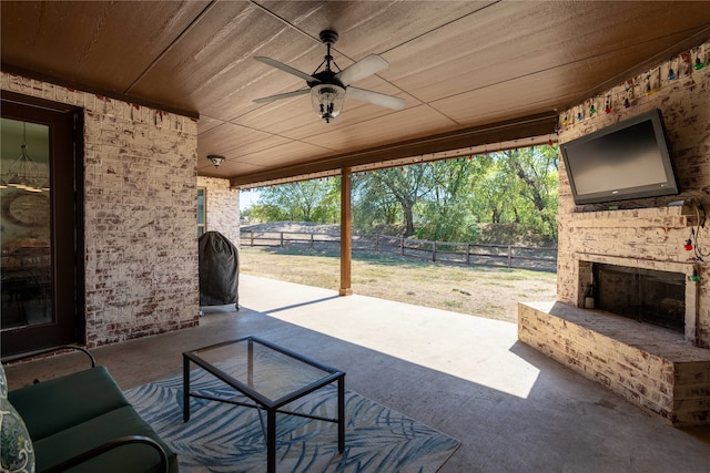 view of patio / terrace with ceiling fan and an outdoor stone fireplace