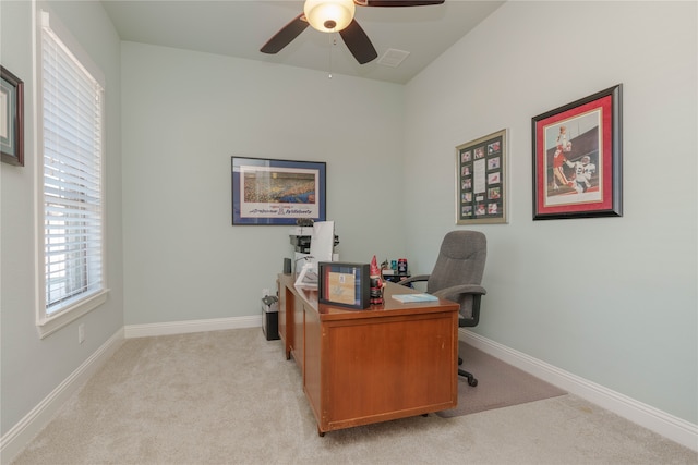 carpeted office space with ceiling fan