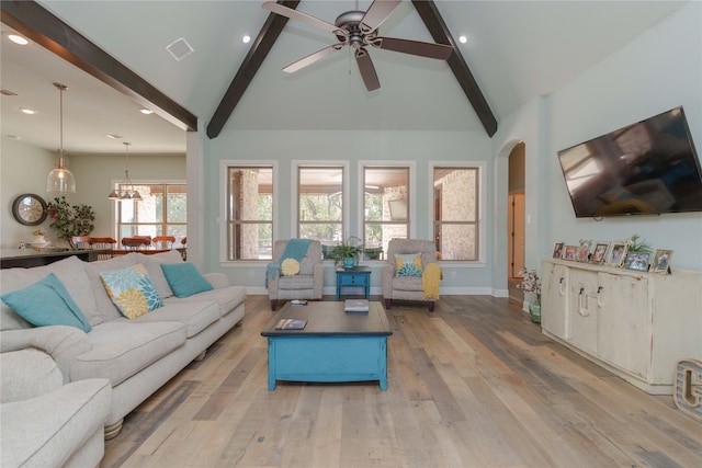 living room featuring beamed ceiling, light hardwood / wood-style flooring, high vaulted ceiling, and ceiling fan with notable chandelier