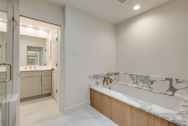 bathroom with vanity and shower with separate bathtub