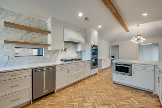 kitchen with white cabinets, appliances with stainless steel finishes, and custom exhaust hood