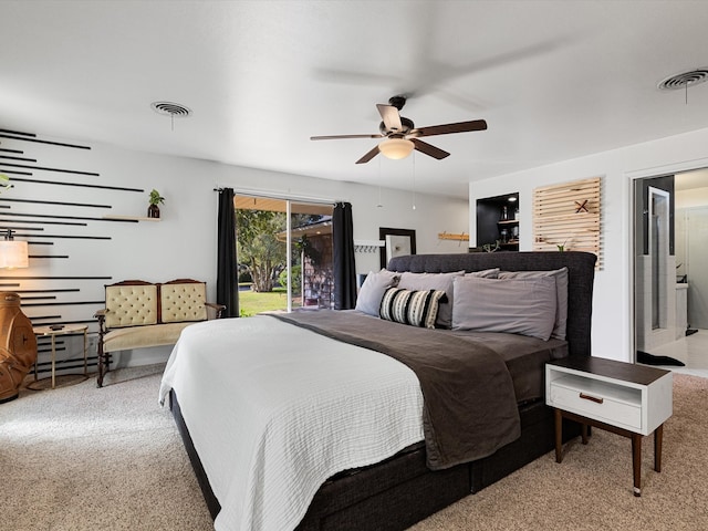 carpeted bedroom with ensuite bathroom, access to exterior, and ceiling fan