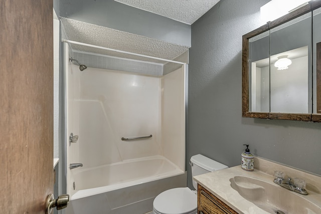 full bathroom with shower / washtub combination, vanity, a textured ceiling, and toilet