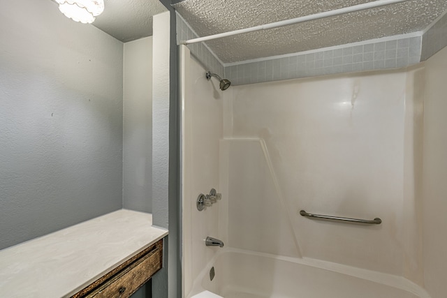 bathroom featuring a textured ceiling and  shower combination