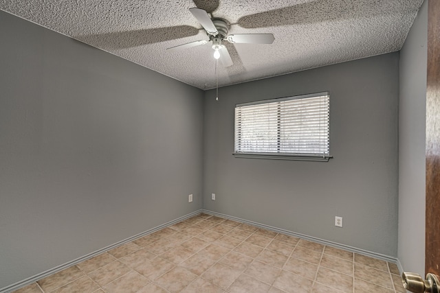 empty room with ceiling fan and a textured ceiling