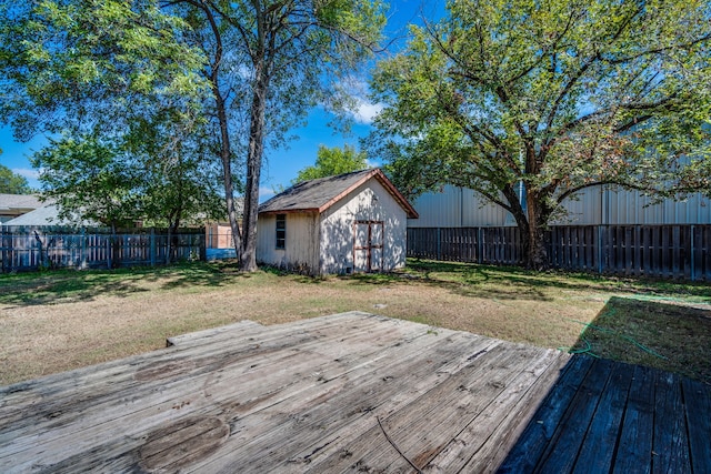 wooden deck featuring a lawn and a storage shed