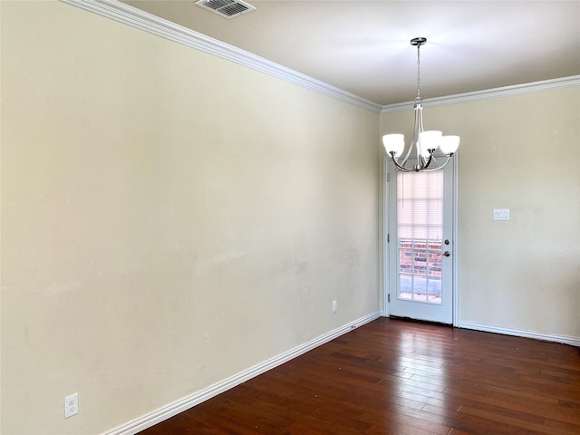 unfurnished room with crown molding, dark hardwood / wood-style floors, and an inviting chandelier