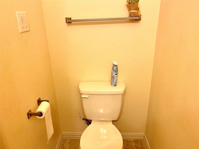 bathroom with toilet and tile patterned flooring