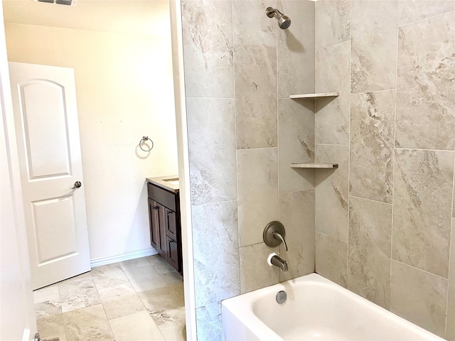 bathroom with vanity and tiled shower / bath combo