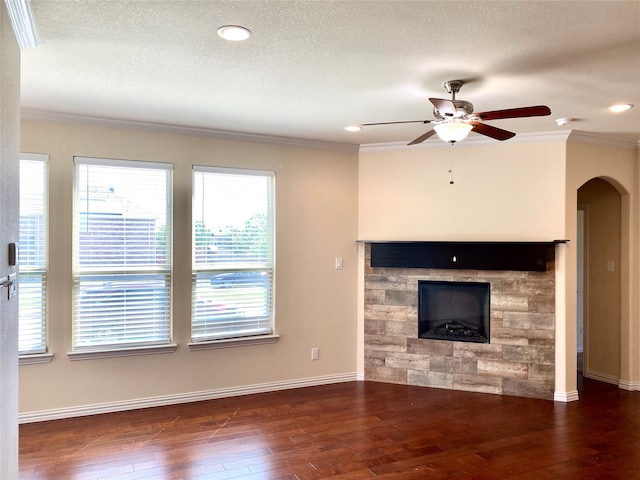 unfurnished living room with dark hardwood / wood-style floors, a textured ceiling, a fireplace, and ceiling fan