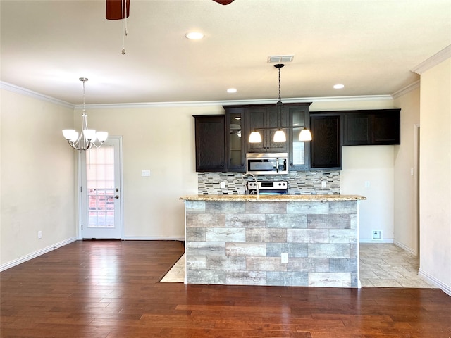 kitchen with dark brown cabinets, light stone counters, dark hardwood / wood-style floors, pendant lighting, and stainless steel appliances